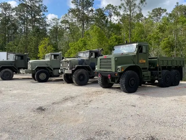 Fleet of six-wheel trucks parked in a row