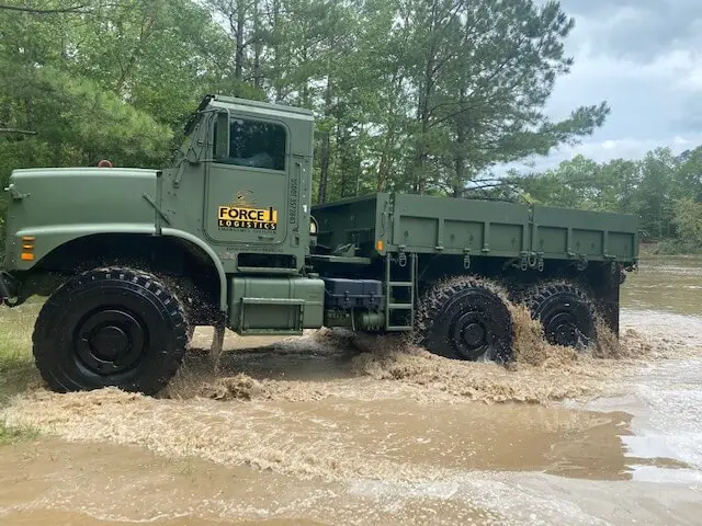 Force 1 Logistics truck driving through flood water