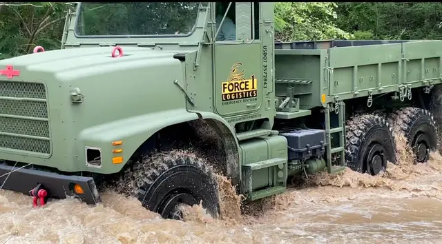 Close view of a Force 1 Logistics truck in flood water